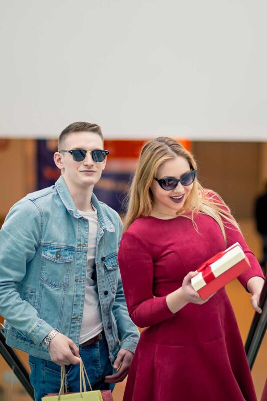 Handsome man with girlfriends on escalator-with-shopping-bags from Fomlaza Store