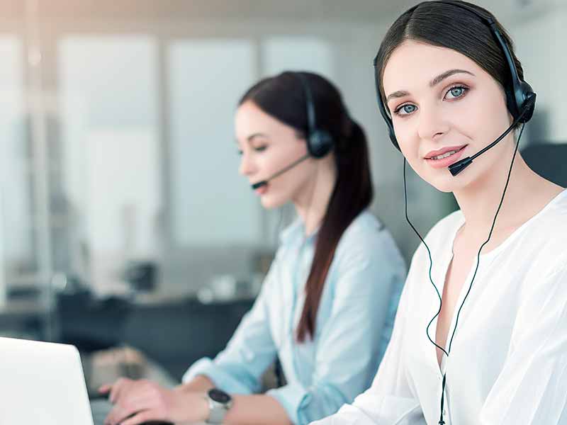 a-Female-customer-support-operator-from-Gomlaza-Store-wearing-the-headset-and-smiling-with-colleague