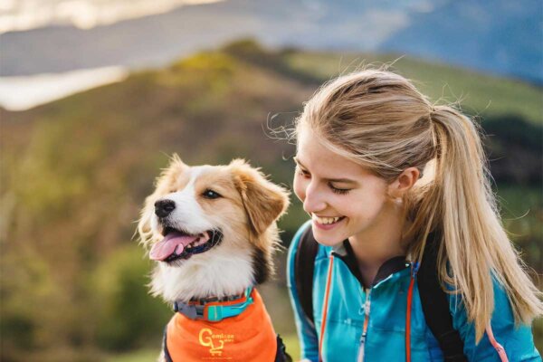 Colorful Pup is wearing Remote Dog Training Collar with Pretty Girl Trainer in the nature outdoor